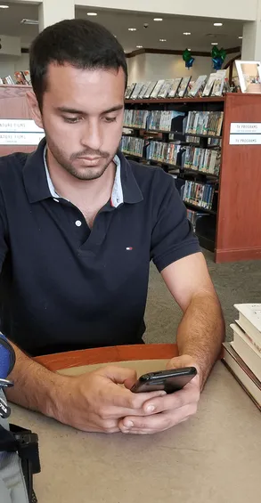A student skimming a chapter on a phone
